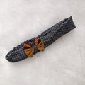 Decorative napkin ring with geometric design on a textured white surface

