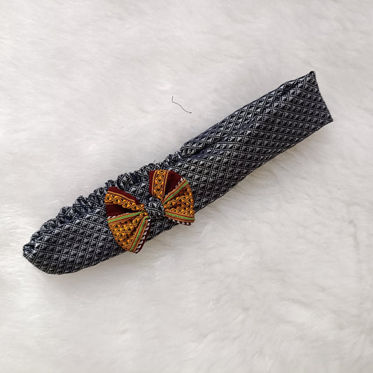 Decorative napkin ring with geometric design on a textured white surface

