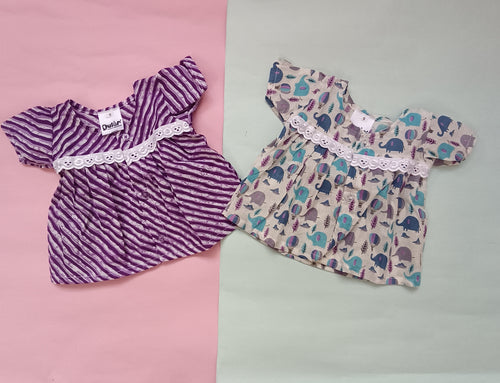 Two baby dresses on a pink and gray background

