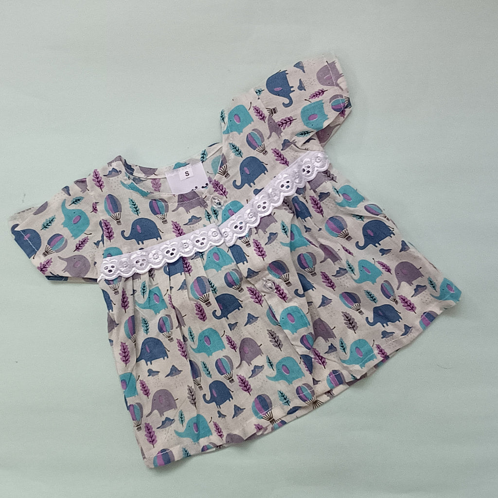 Baby dress with elephant pattern on a light gray background

